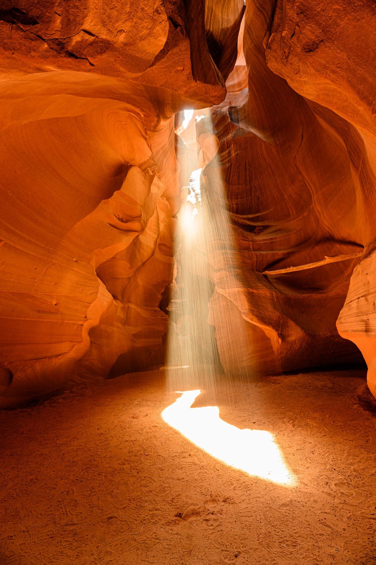 Swirling orange sandstone walls curving through a slot canyon