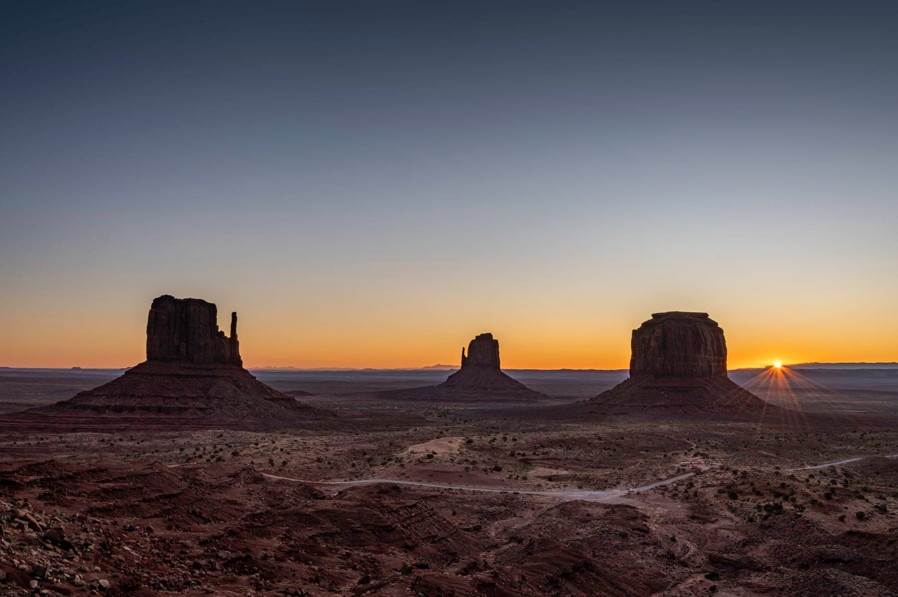 Desert buttes and mesas receding under warm late light